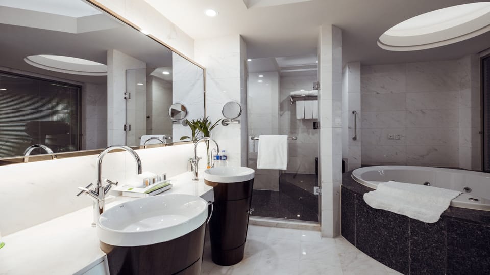 Suite, 1 King Bed | Bathroom | Shower, free toiletries, hair dryer, bathrobes