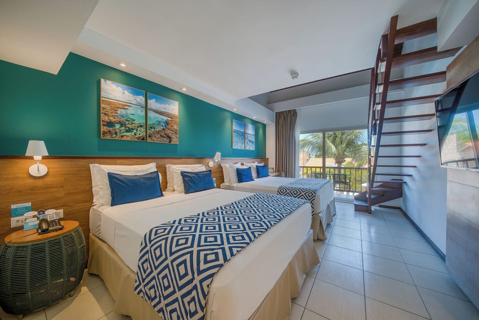 Family Room | Minibar, in-room safe, individually decorated, desk