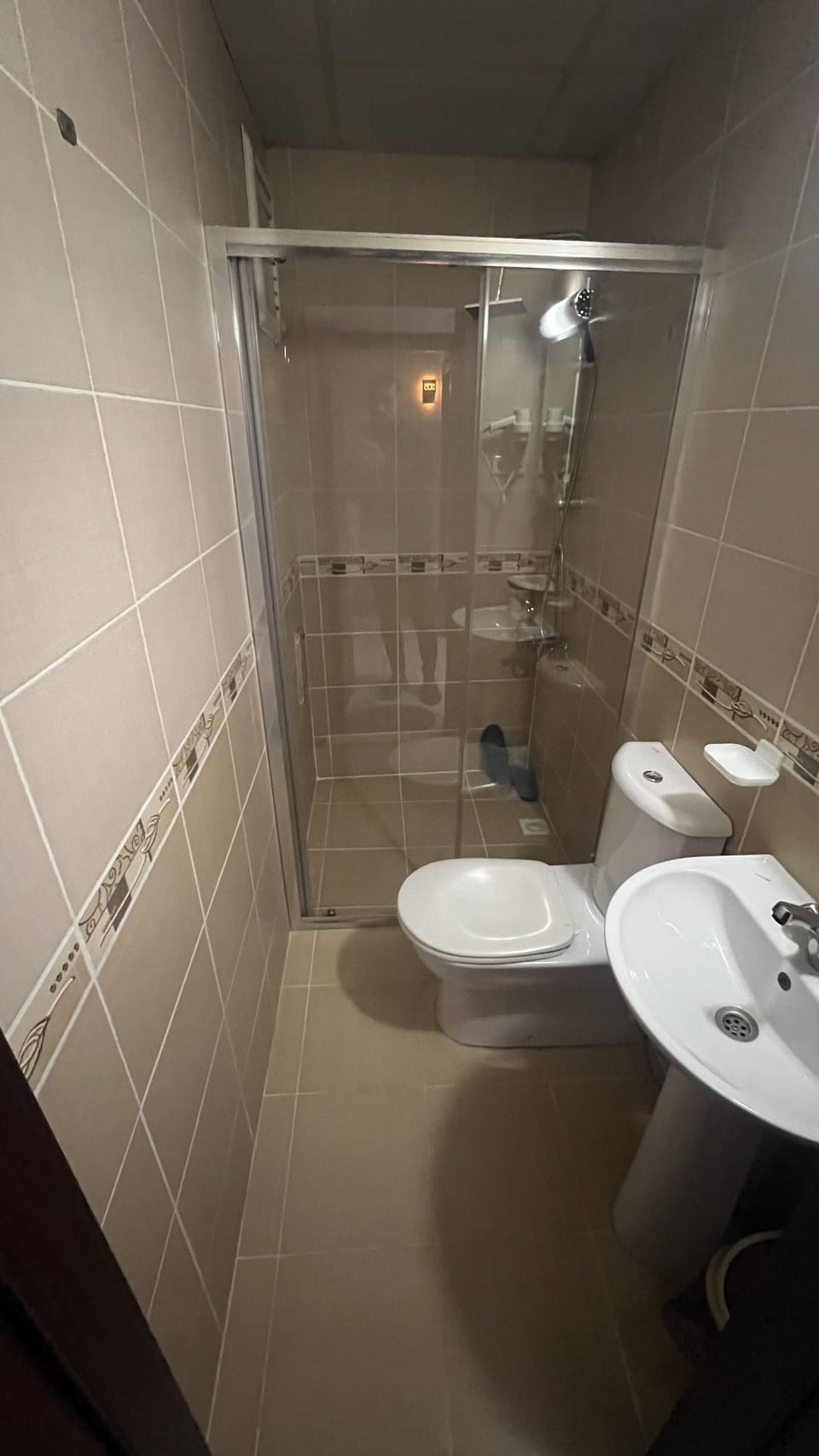 Shower, hair dryer, slippers, towels