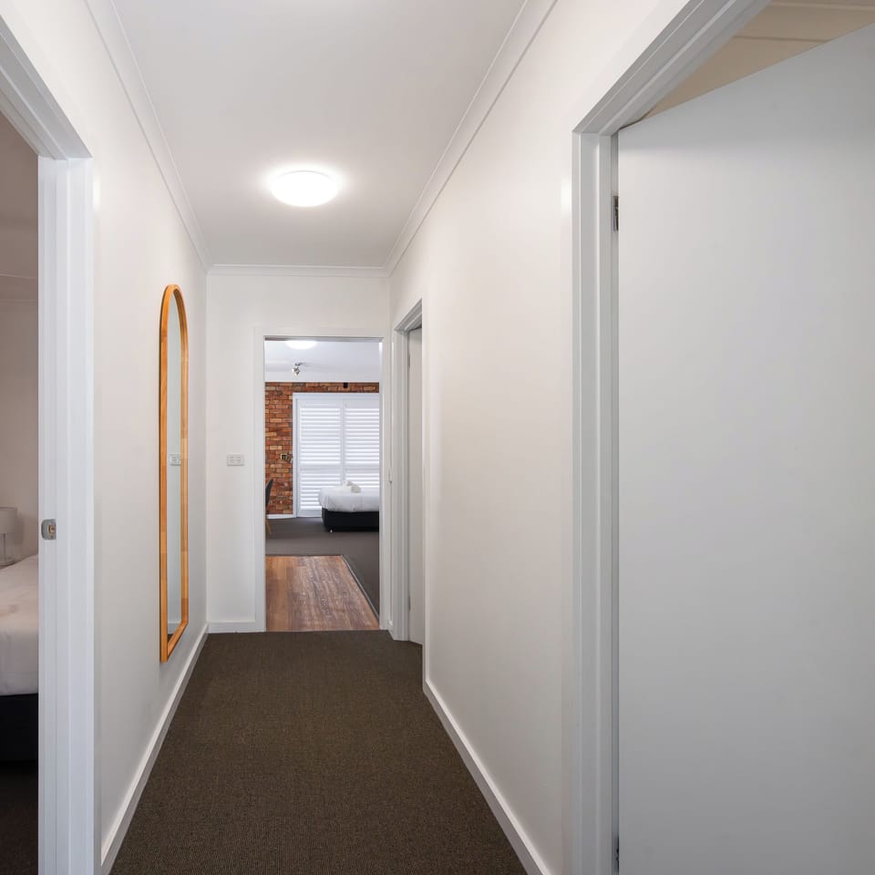 Standard Apartment | Desk, laptop workspace, blackout drapes, iron/ironing board