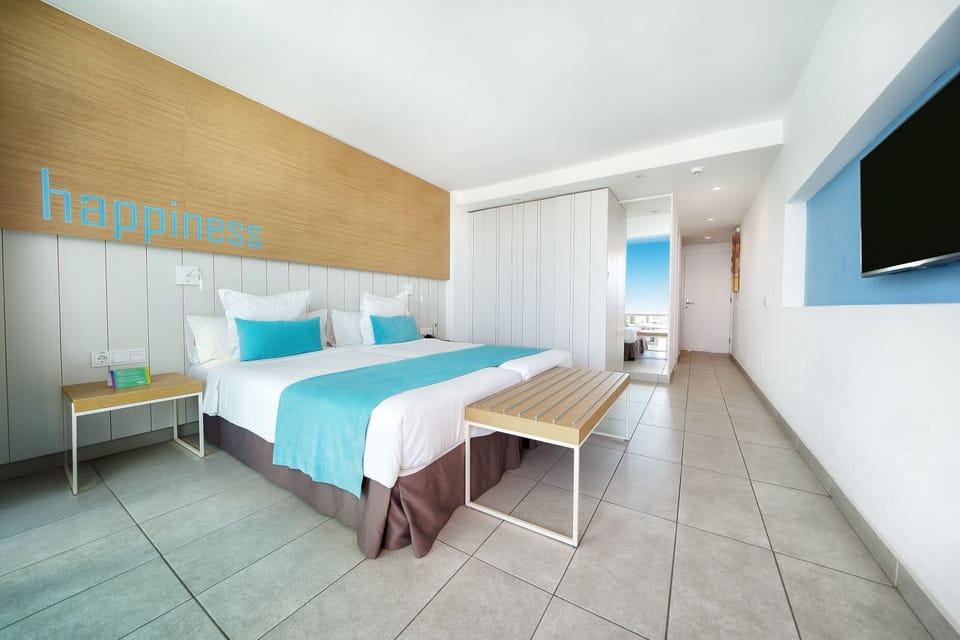 Deluxe Room, Partial Sea View | In-room safe, desk, laptop workspace, blackout drapes