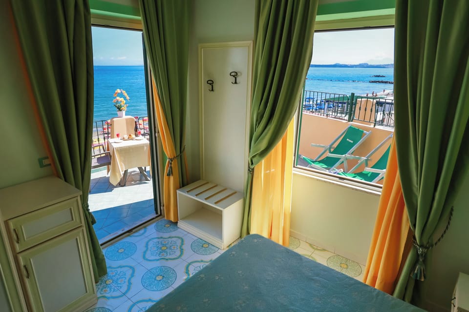 Double Room, Terrace, Sea View | Minibar, in-room safe, desk, laptop workspace