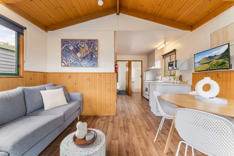 Standard Two Bedroom Cabin, sleeps 6 | Living area | Flat-screen TV, DVD player