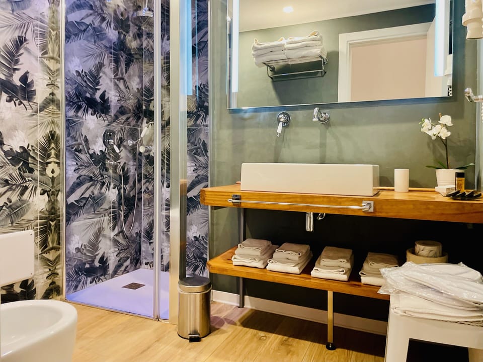 Family Triple Room, Non Smoking, Balcony | Bathroom | Shower, rainfall showerhead, designer toiletries, hair dryer