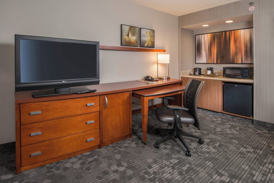 Premium bedding, desk, laptop workspace, blackout drapes