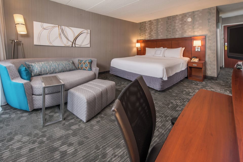 Premium bedding, desk, laptop workspace, blackout drapes