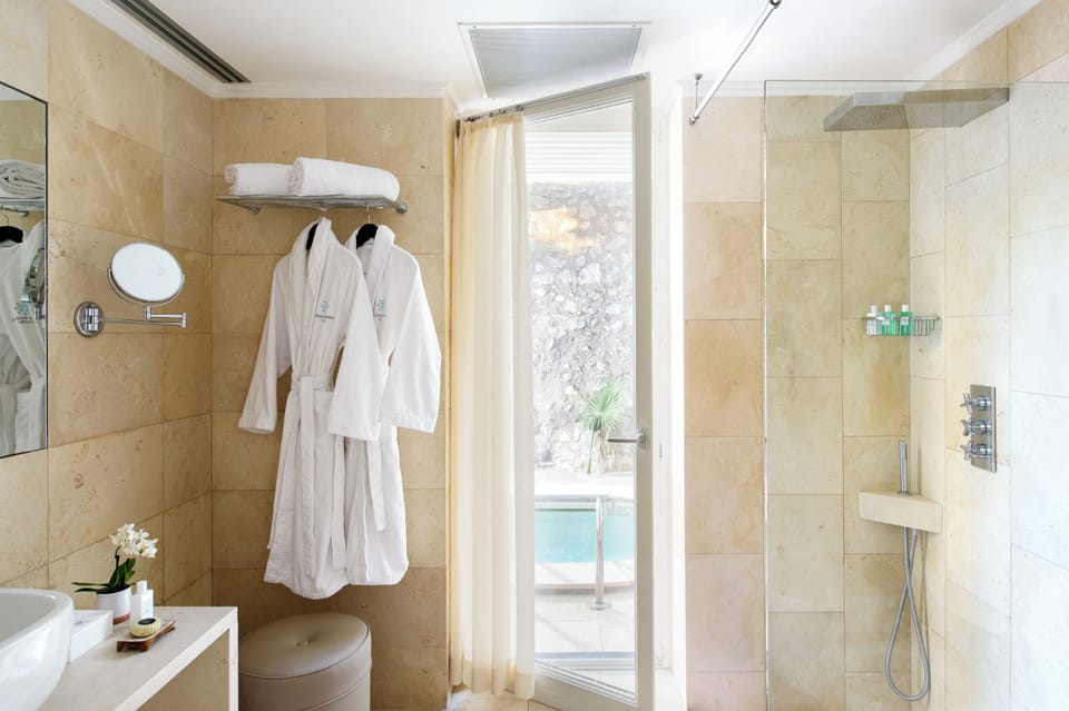 Suite Sea View With Pool | Bathroom | Combined shower/tub, rainfall showerhead, free toiletries, hair dryer