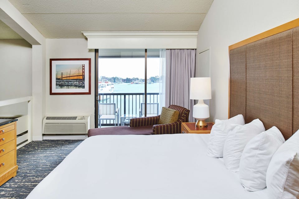 Suite, 1 King Bed, Non Smoking, Balcony | Living area | 49-inch flat-screen TV with cable channels, TV, pay movies
