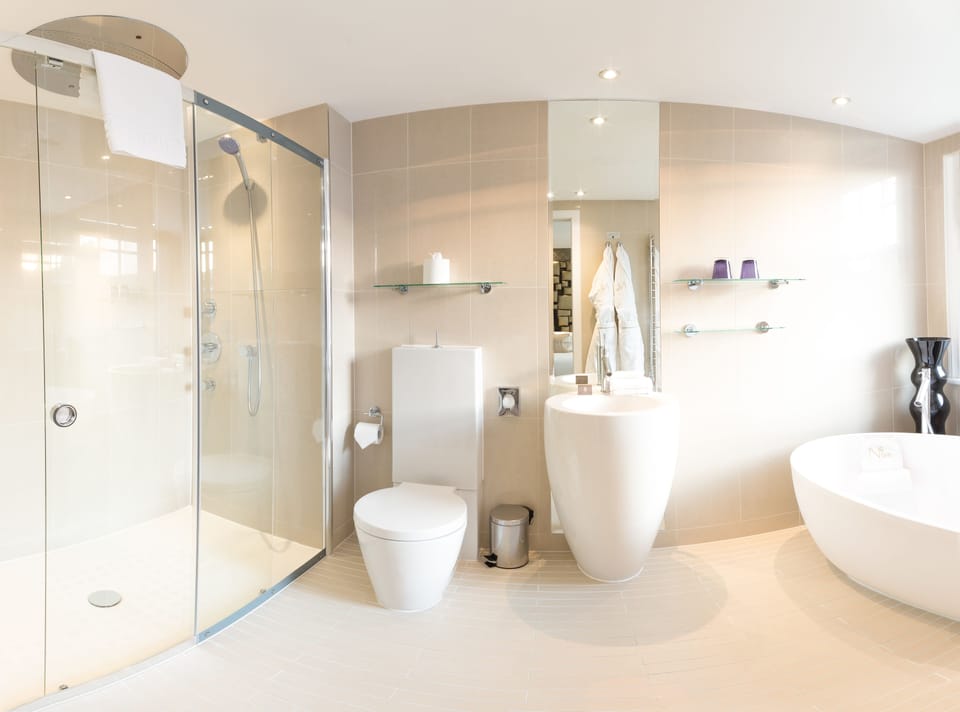 Grand Suite, 1 King Bed | Bathroom | Rainfall showerhead, designer toiletries, hair dryer, bathrobes