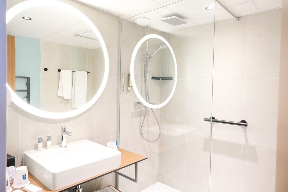 Shower, hair dryer, slippers, towels