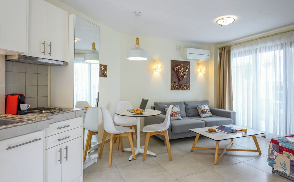 Deluxe Apartment, Partial Sea View | Living area | Flat-screen TV