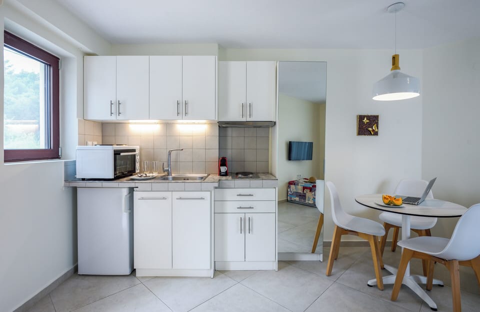 Deluxe Apartment, Partial Sea View | Private kitchen | Fridge, microwave, stovetop, coffee/tea maker