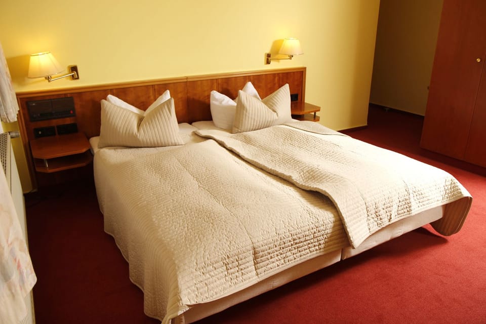 Hypo-allergenic bedding, desk, laptop workspace, blackout drapes