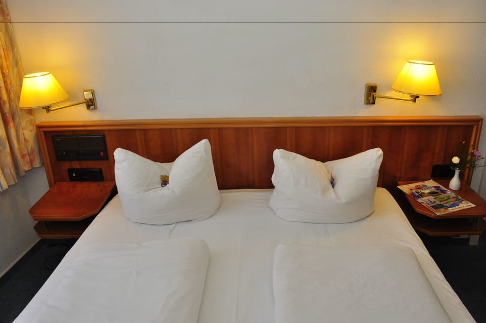 Hypo-allergenic bedding, desk, laptop workspace, blackout drapes