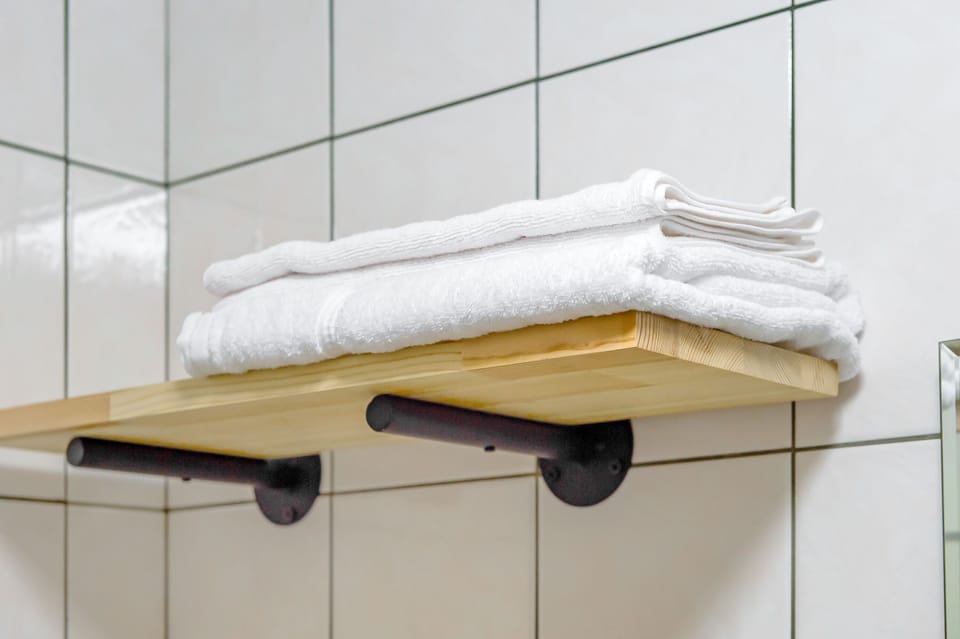 Twin Room | Bathroom | Shower, hair dryer, slippers, towels