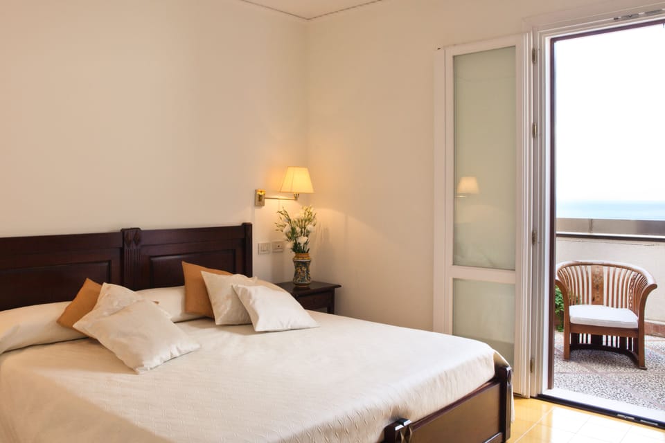 Double Room, Terrace, Partial Sea View | Minibar, in-room safe, individually furnished, desk