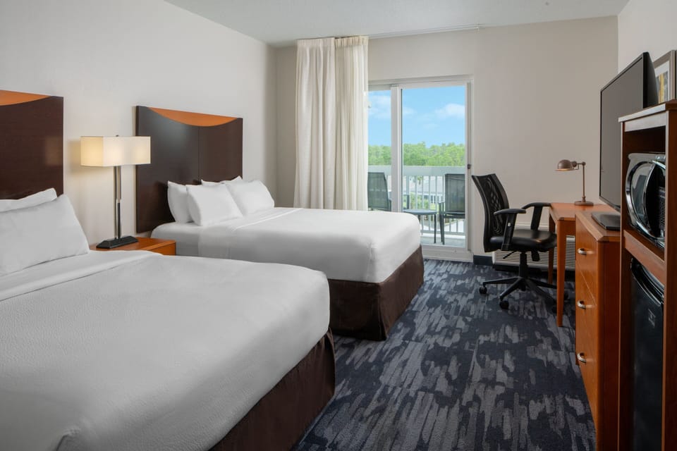 Room, 2 Queen Beds, Balcony | In-room safe, desk, iron/ironing board, free cribs/infant beds