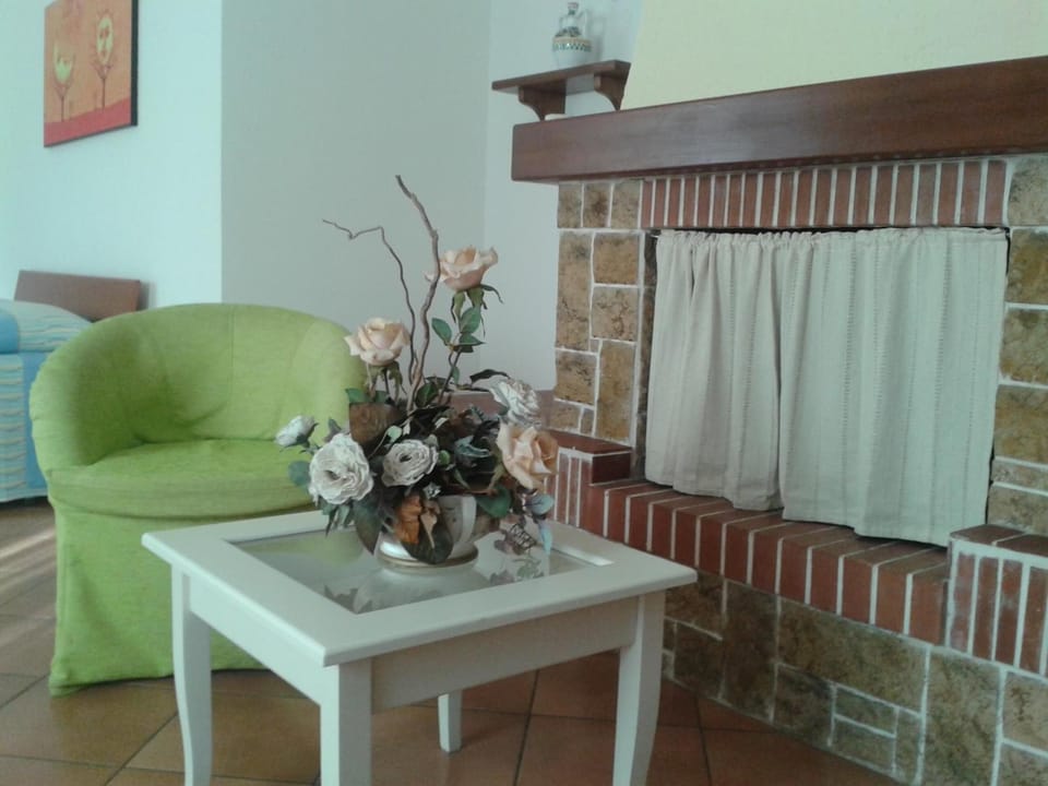 Quadruple Room, Garden View | Living room | Flat-screen TV