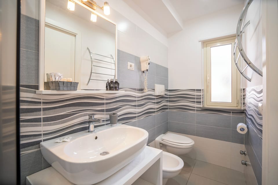 Quadruple Room, Balcony | Bathroom | Shower, hair dryer, bidet, towels