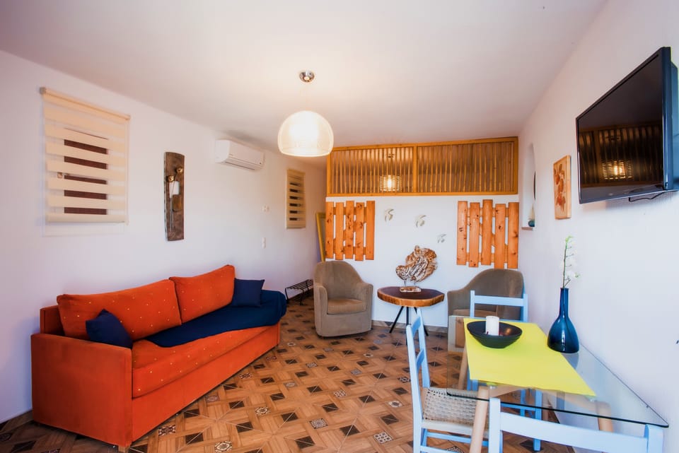 Luxury Triple Room, Smoking, Hill View | Living room | Flat-screen TV
