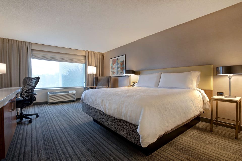 Premium bedding, desk, laptop workspace, iron/ironing board