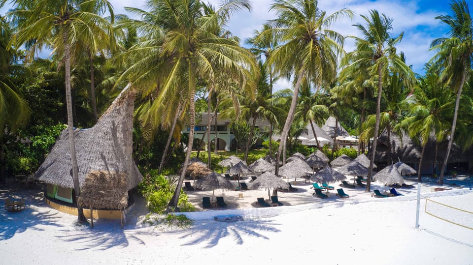 On the beach, white sand, sun loungers, beach umbrellas