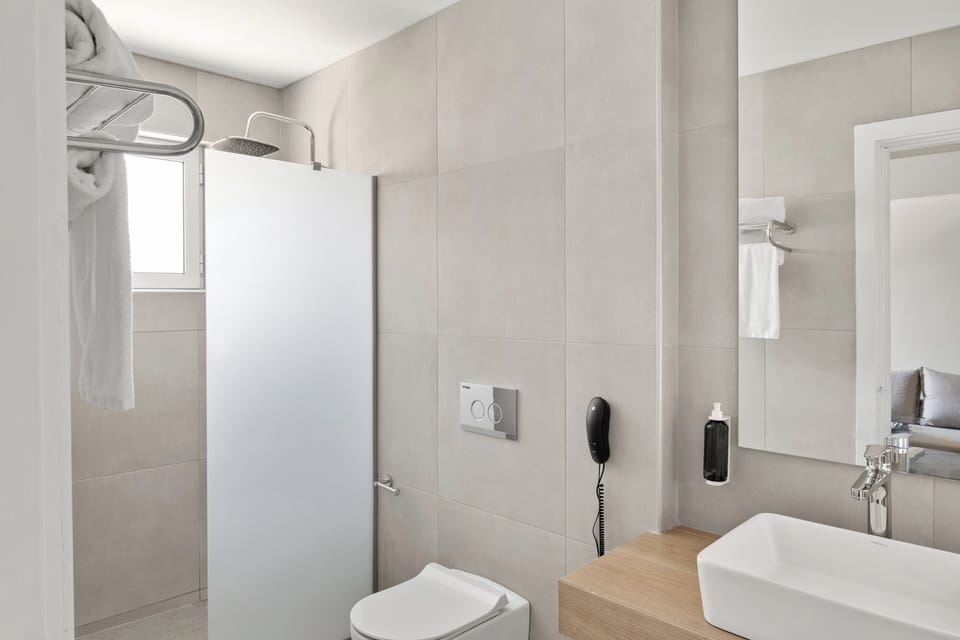 Shower, rainfall showerhead, hair dryer, towels