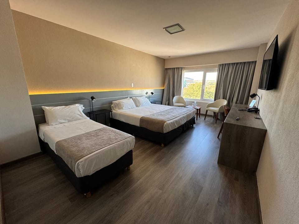 Triple Room | Minibar, in-room safe, desk, blackout drapes
