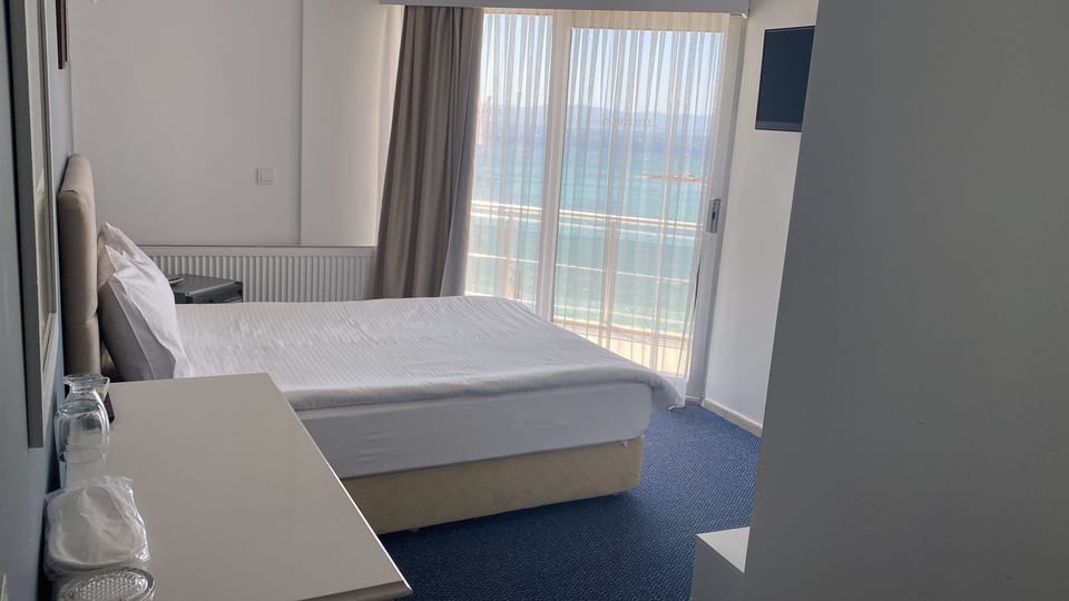 Standard Room, Sea View | In-room safe, desk, iron/ironing board (on request), bed sheets