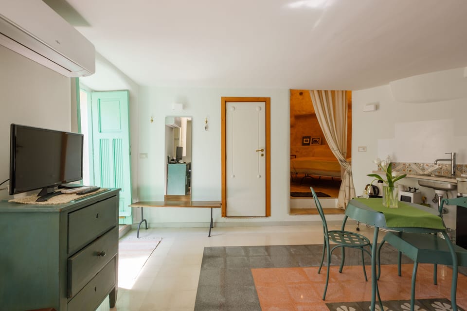 Deluxe Apartment, 1 Queen Bed with Sofa bed, Accessible, Non Smoking (in cave) | Living area | Flat-screen TV, fireplace, heated floors