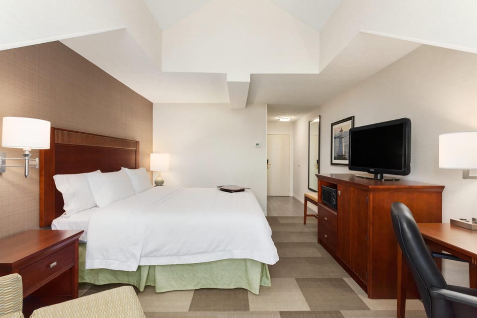 Hypo-allergenic bedding, desk, laptop workspace, blackout drapes