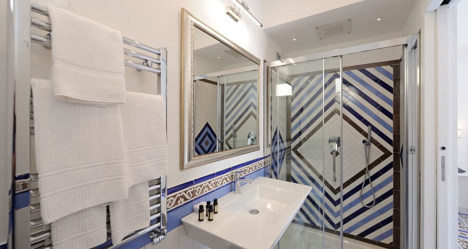 Suite, Balcony | Bathroom | Shower, free toiletries, hair dryer, slippers