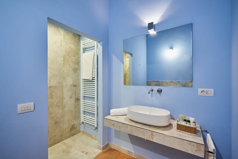 Standard Suite | Bathroom | Shower, deep soaking tub, free toiletries, bathrobes