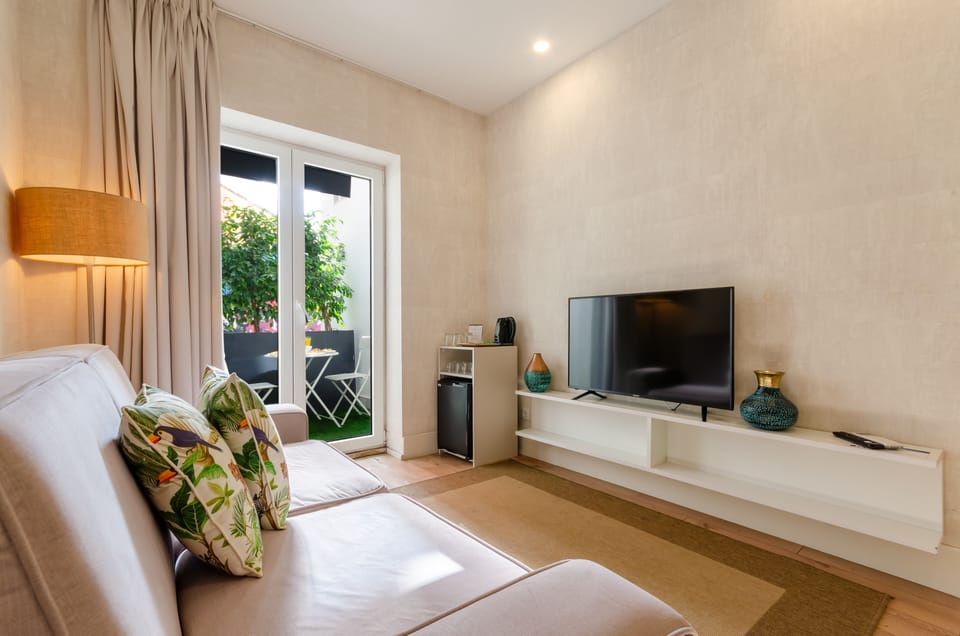Suite, Patio, City View | Living area | Flat-screen TV