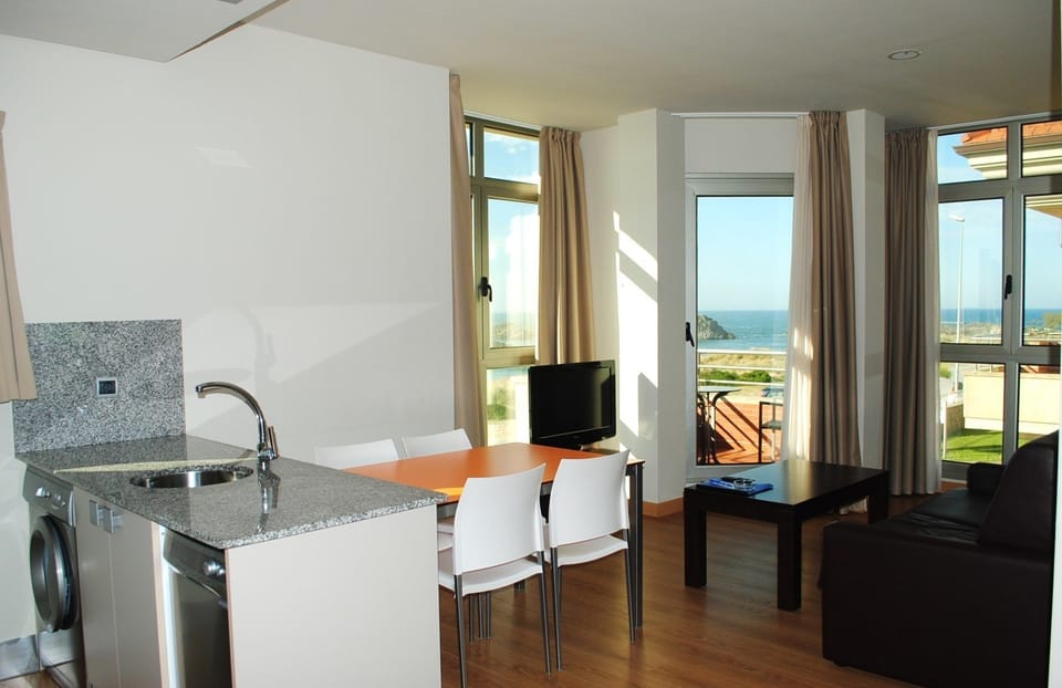 Deluxe Apartment, 1 Bedroom, Beach View | Living room | Flat-screen TV