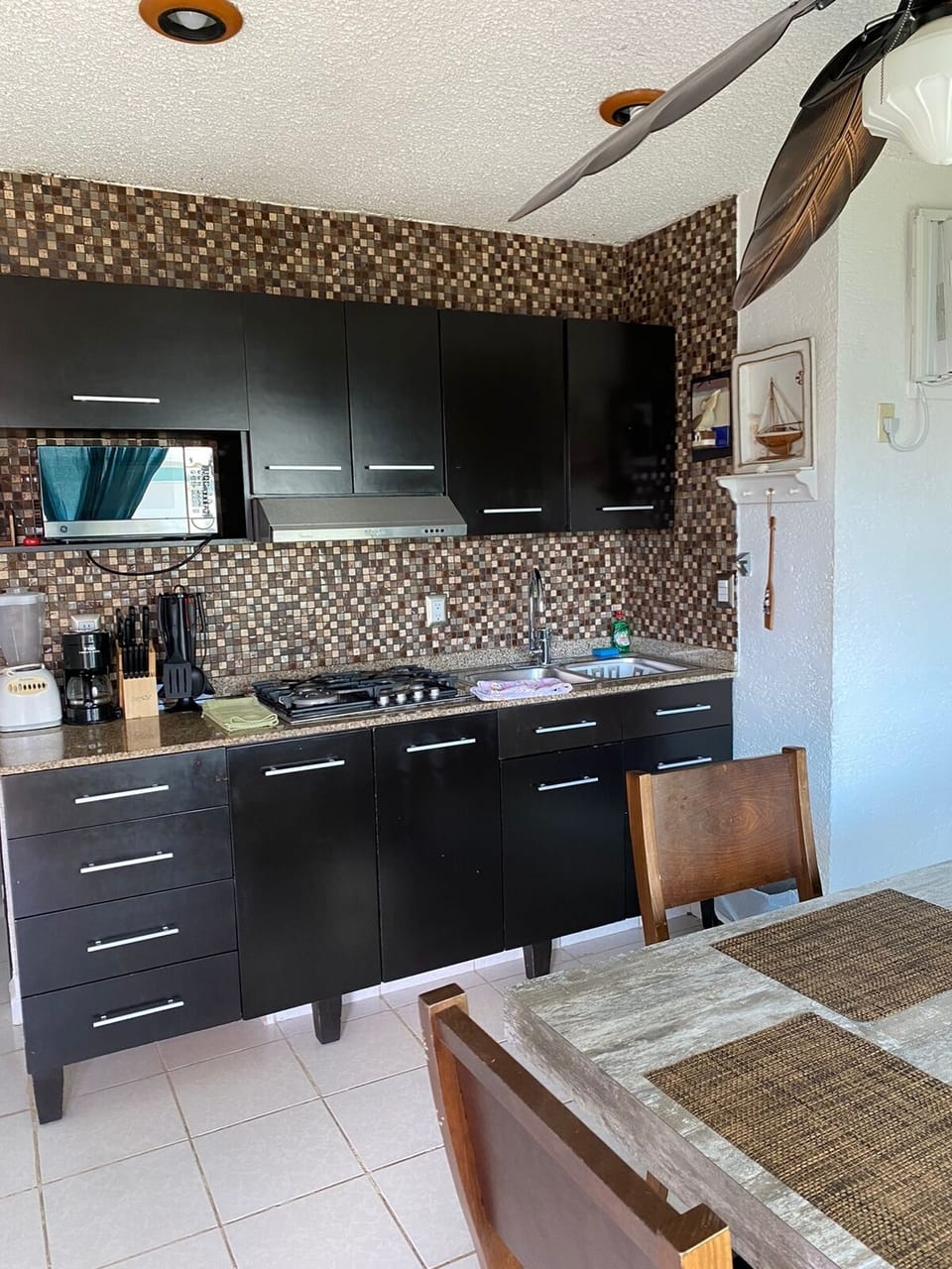 Full-size fridge, microwave, stovetop, cookware/dishes/utensils