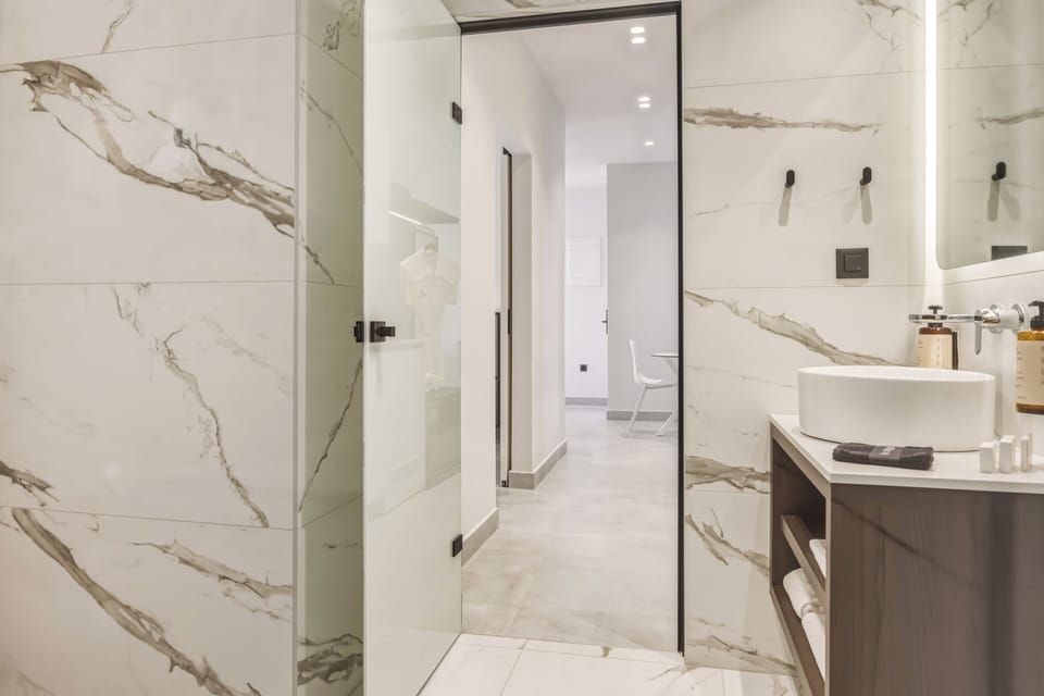 Suite, 1 Bedroom, Sea View | Bathroom | Rainfall showerhead, free toiletries, hair dryer, bathrobes