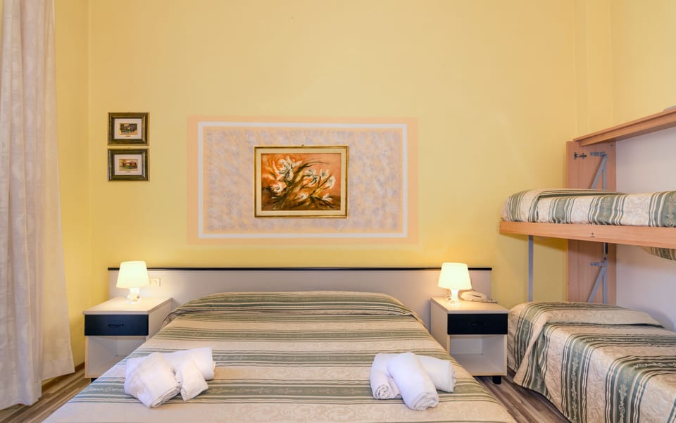 Quadruple Room | 1 bedroom, down comforters, Select Comfort beds, desk