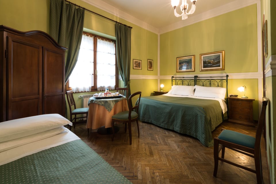 Triple Room | Minibar, in-room safe, individually decorated, desk