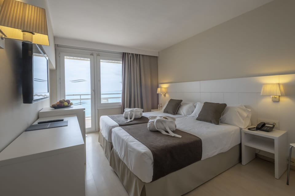 Double or Twin Room, Balcony, Sea View | Down comforters, in-room safe, desk, blackout drapes