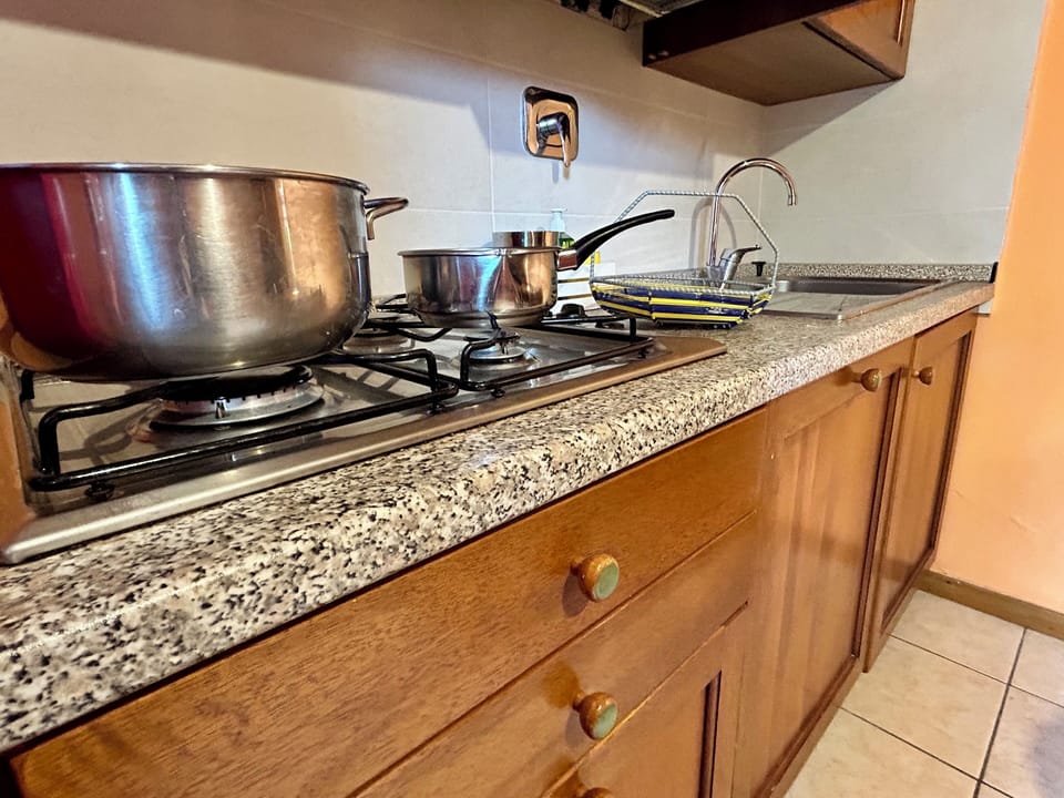 Standard Apartment, Garden View (Gemelli) | Private kitchen | Fridge, coffee/tea maker, electric kettle, highchair