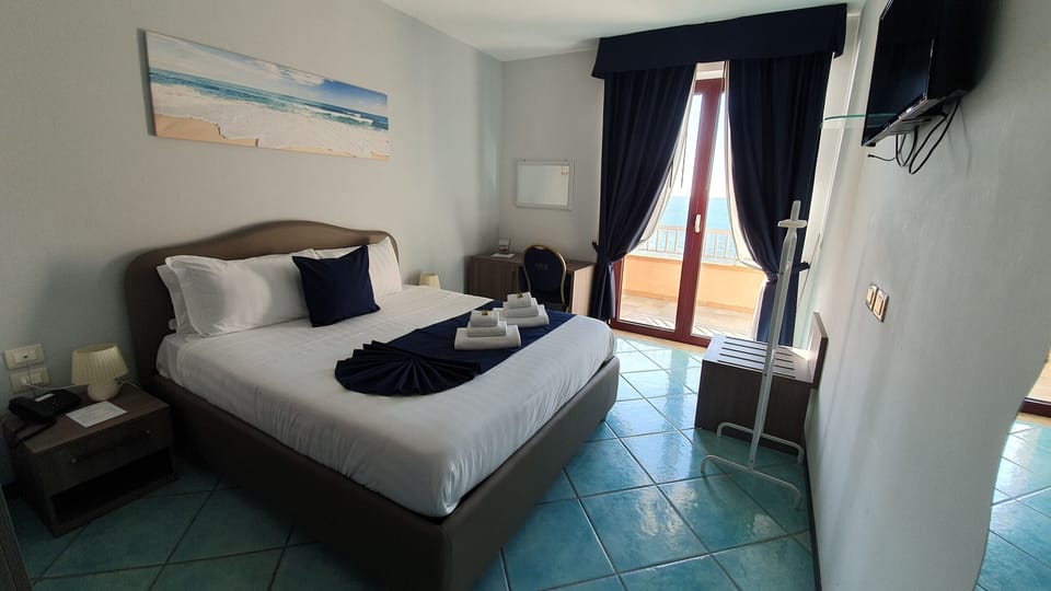 Double Room, Sea View | Down comforters, minibar, in-room safe, individually decorated
