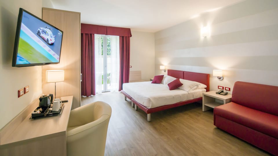 Deluxe Quadruple Room | Premium bedding, minibar, in-room safe, individually furnished