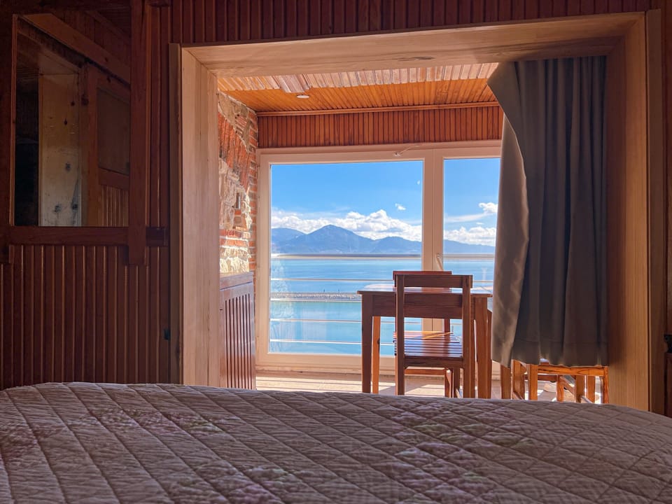 Panoramic Studio, 2 Bedrooms, Lake View | Living area | 40-cm LCD TV with satellite channels, TV, books
