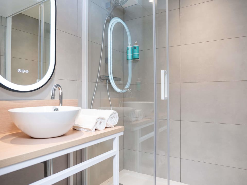 Bathtub, eco-friendly toiletries, hair dryer, towels