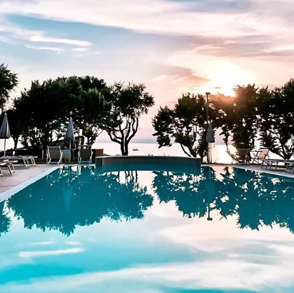 Outdoor pool, open 8:00 AM to 8:00 PM, pool umbrellas, sun loungers