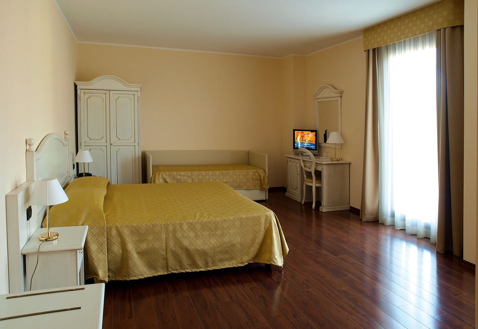 Superior Triple Room | Minibar, in-room safe, desk, blackout drapes
