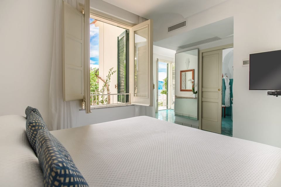 Double Room, Partial Sea View | Premium bedding, minibar, in-room safe, desk