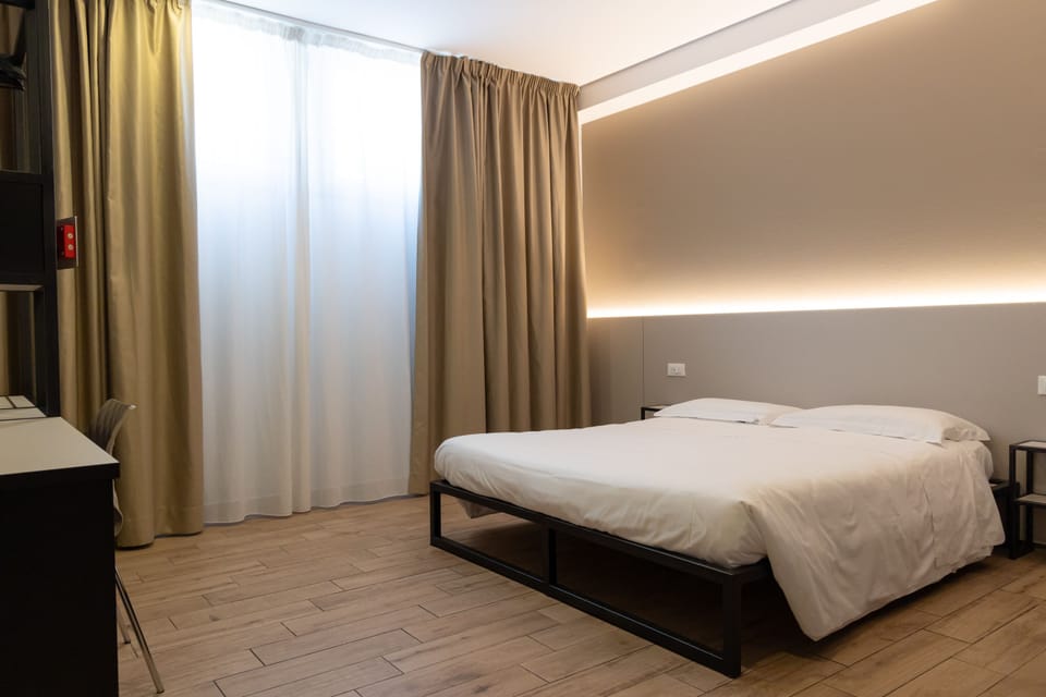 Economy Room, 1 Bedroom | Minibar, in-room safe, desk, soundproofing