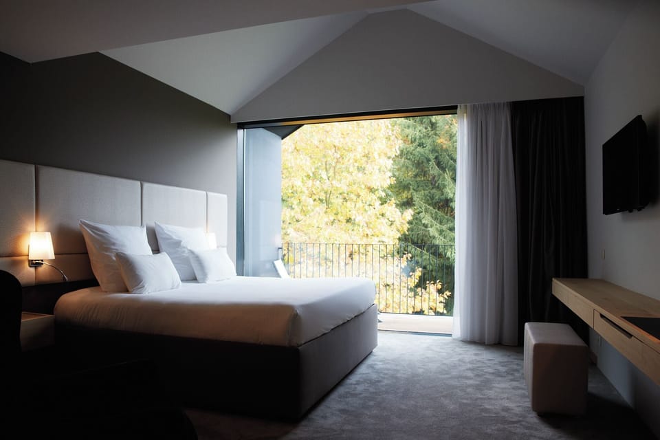 Deluxe Double Room | Minibar, in-room safe, desk, blackout drapes